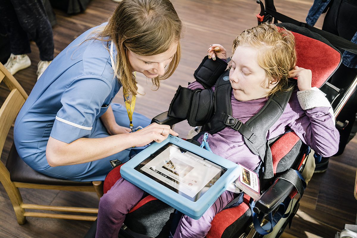 Assistant and student looking at tablet